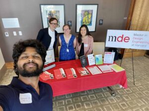 Red conference booth with 4 GSD representatives. 