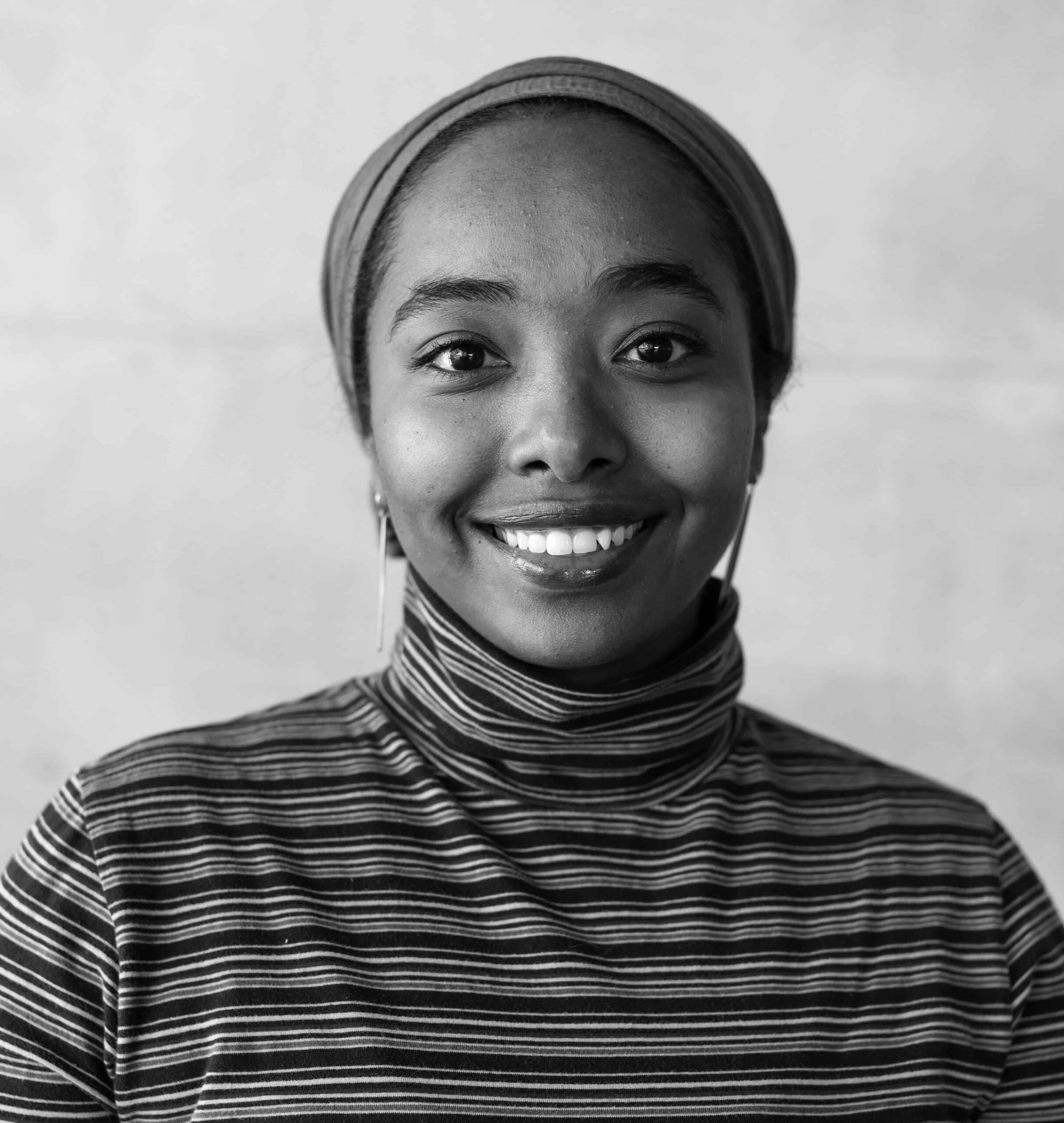 Alaa Suliman Hamid smiling headshot in black and white