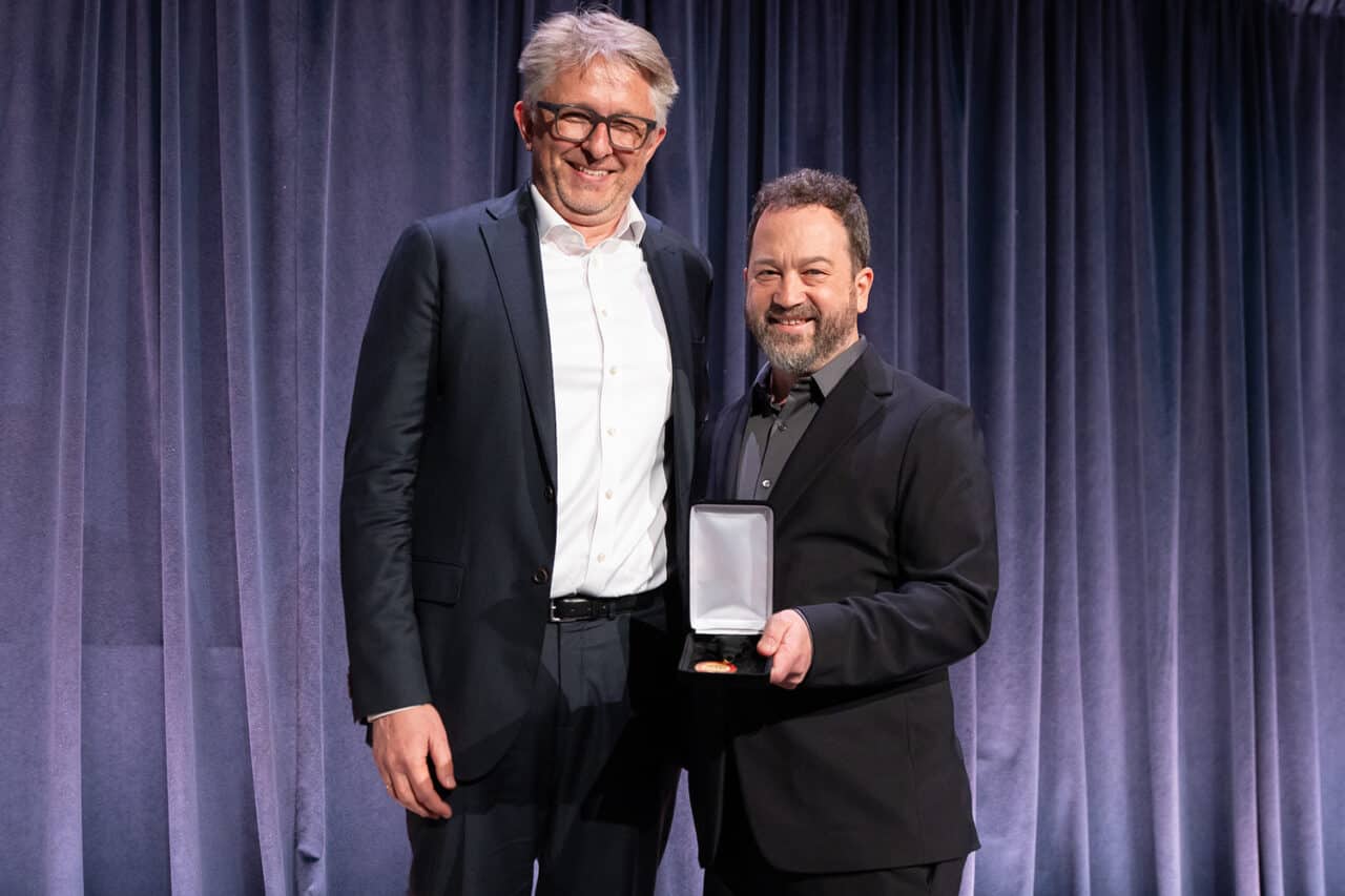Nico Kienzl poses with Champion of Architecture Medal